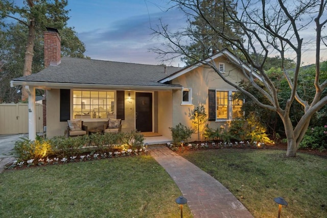 view of front of property featuring a yard and covered porch