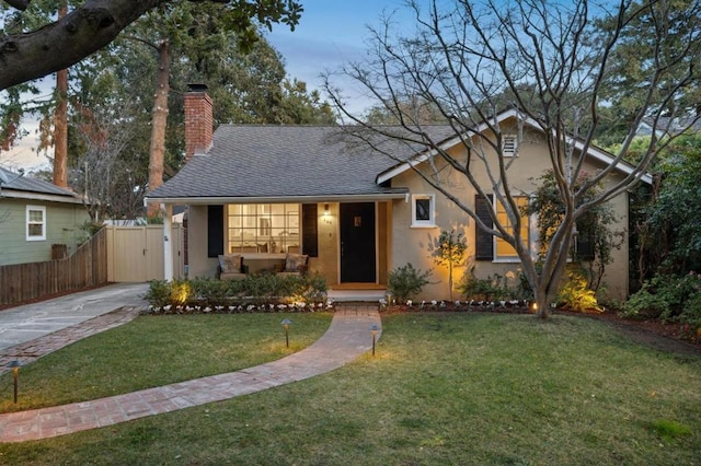 view of front of home with a yard and covered porch