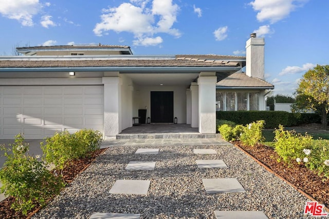 doorway to property featuring a garage