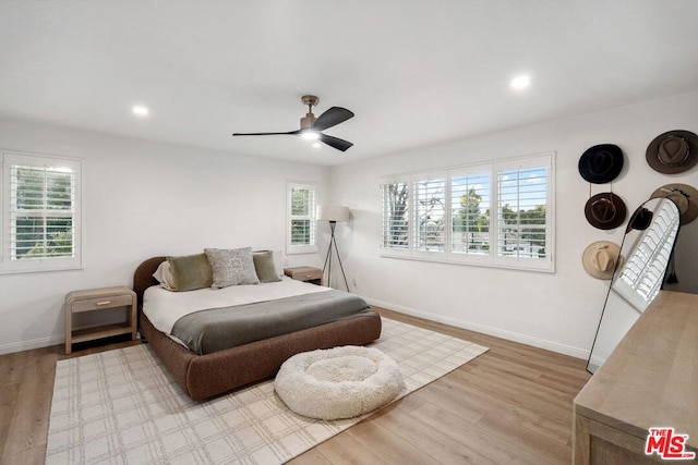 bedroom with ceiling fan and light hardwood / wood-style flooring