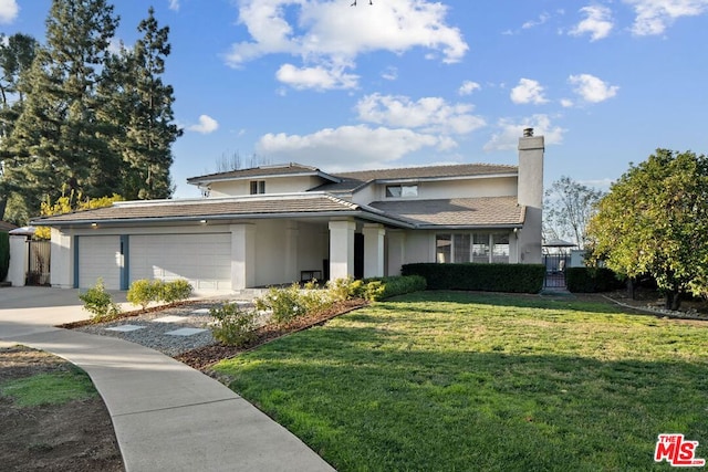 view of front of house featuring a garage and a front yard