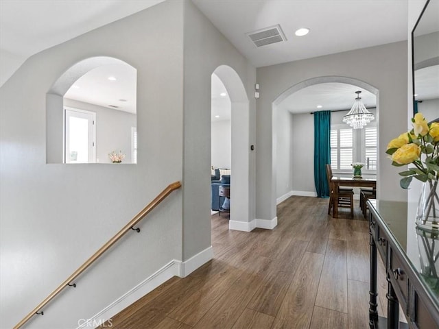 corridor with hardwood / wood-style flooring