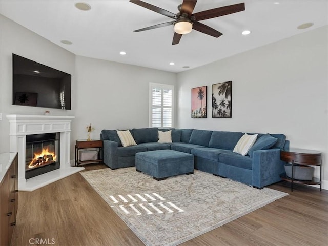 living room featuring hardwood / wood-style flooring and ceiling fan