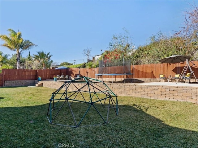 view of yard featuring a patio and a trampoline