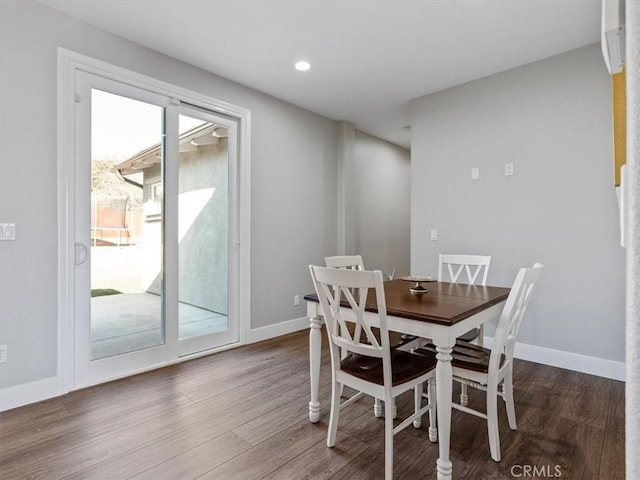 dining space with wood-type flooring