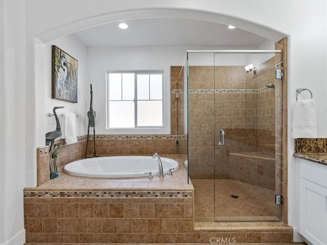 bathroom with vanity and independent shower and bath