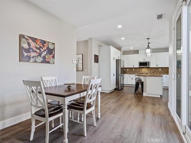 dining room with wood-type flooring