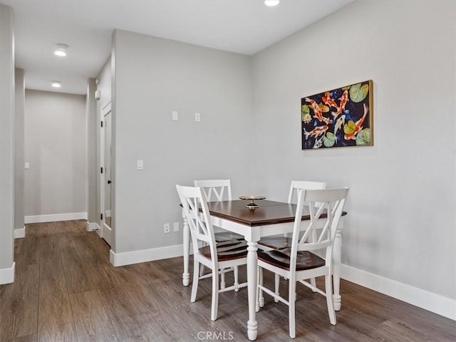 dining space with dark wood-type flooring