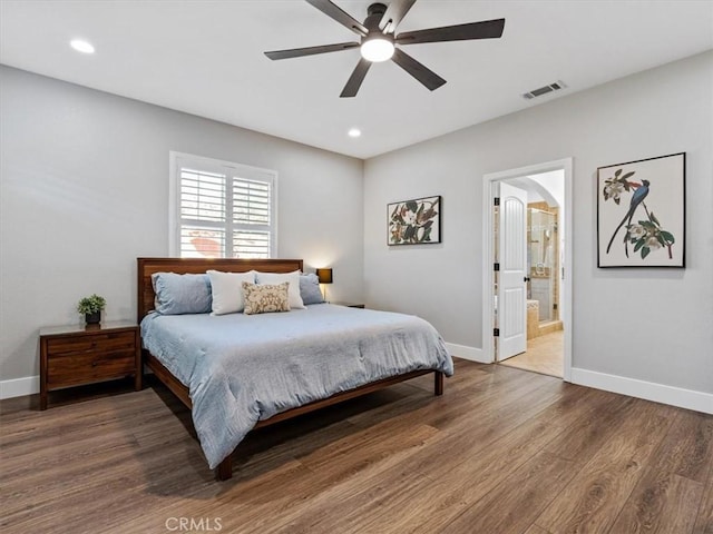 bedroom with hardwood / wood-style flooring, ceiling fan, and ensuite bathroom