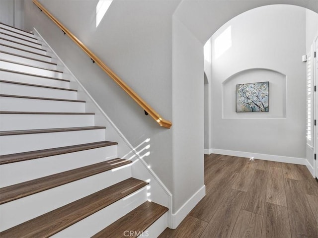 stairway featuring wood-type flooring