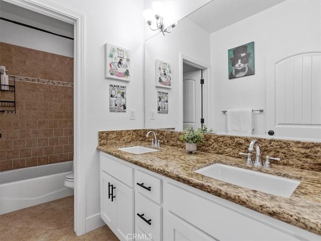 full bathroom featuring tile patterned flooring, vanity, tiled shower / bath, and toilet