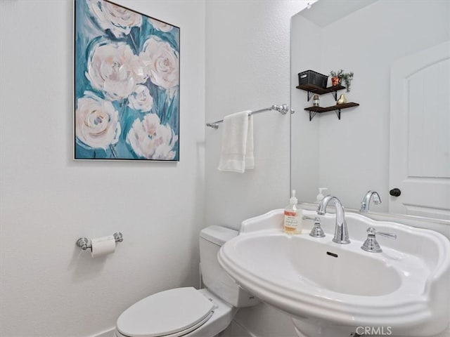 bathroom featuring toilet and sink