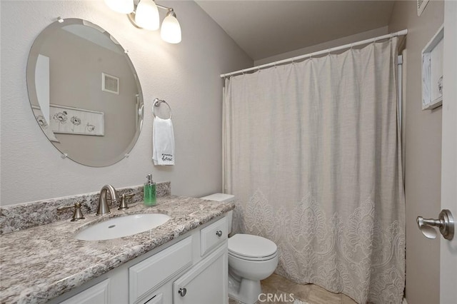 bathroom featuring vanity, curtained shower, and toilet