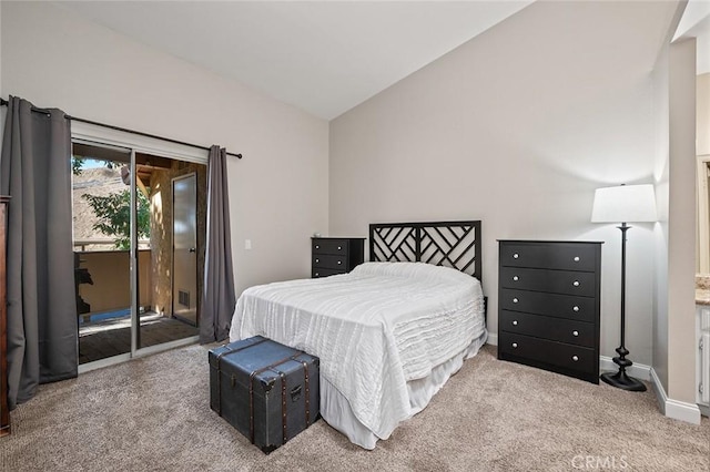 carpeted bedroom featuring vaulted ceiling and access to exterior