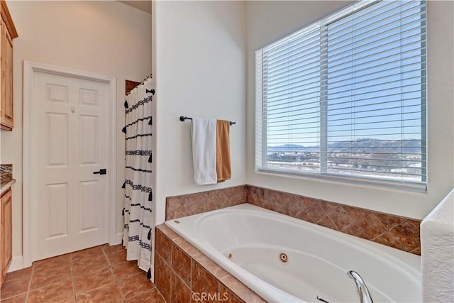 bathroom featuring shower with separate bathtub, vanity, and tile patterned floors