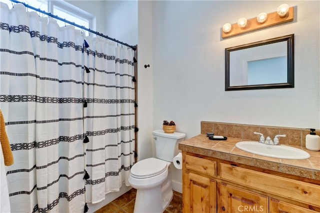 bathroom featuring vanity, toilet, and curtained shower