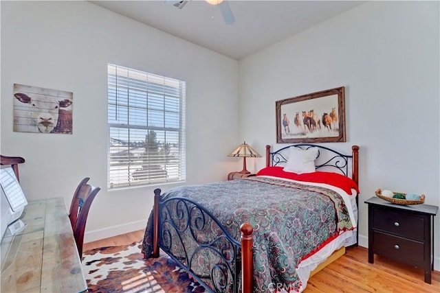 bedroom with ceiling fan and light wood-type flooring