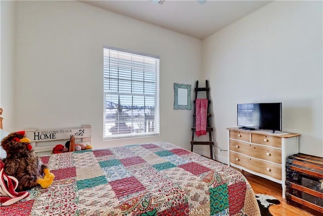 bedroom with hardwood / wood-style flooring