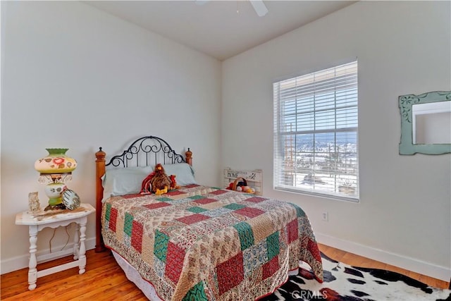 bedroom with light hardwood / wood-style floors and ceiling fan