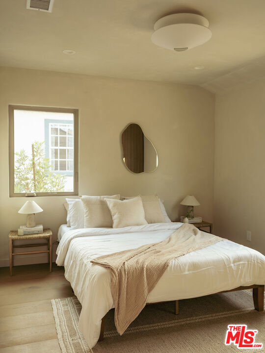 carpeted bedroom featuring lofted ceiling