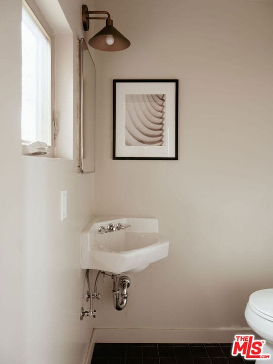 bathroom with tile patterned floors, toilet, and sink