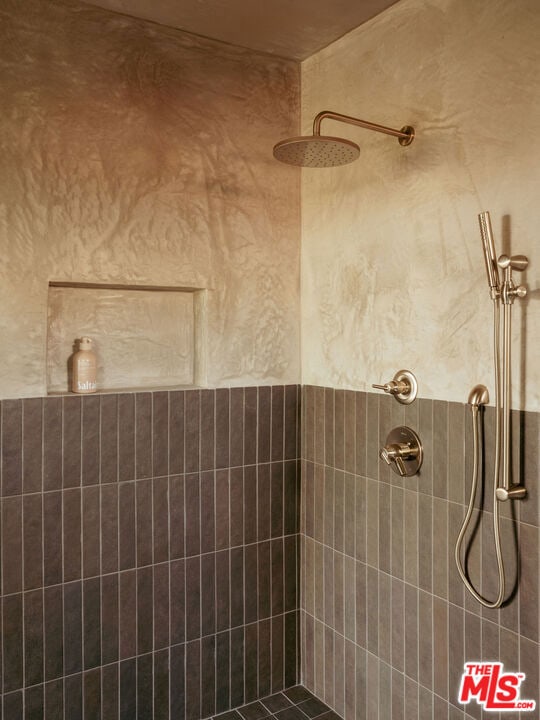 bathroom with a tile shower