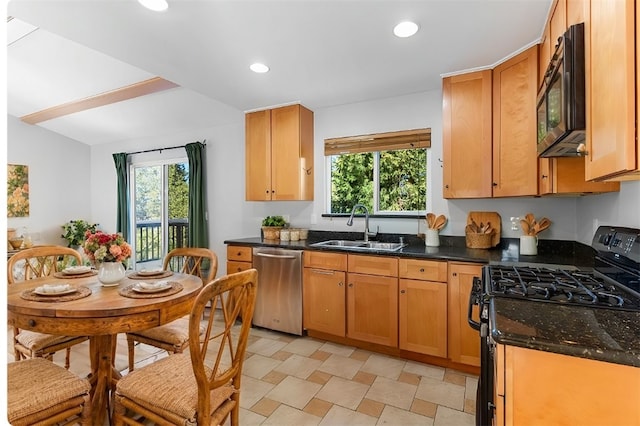 kitchen with sink, plenty of natural light, black appliances, and dark stone counters