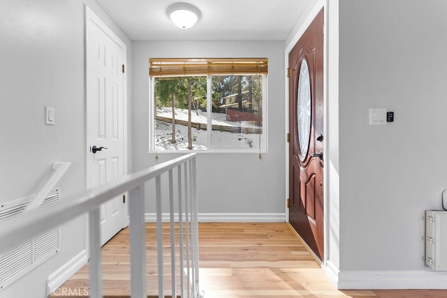 foyer entrance with light hardwood / wood-style flooring