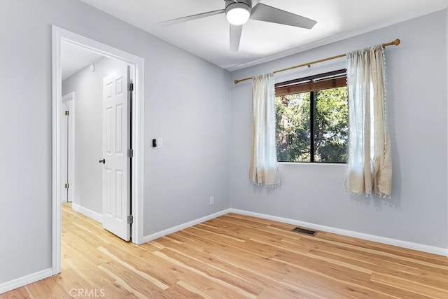 unfurnished room with ceiling fan and light hardwood / wood-style floors