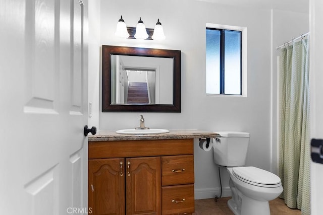 bathroom with tile patterned flooring, vanity, and toilet