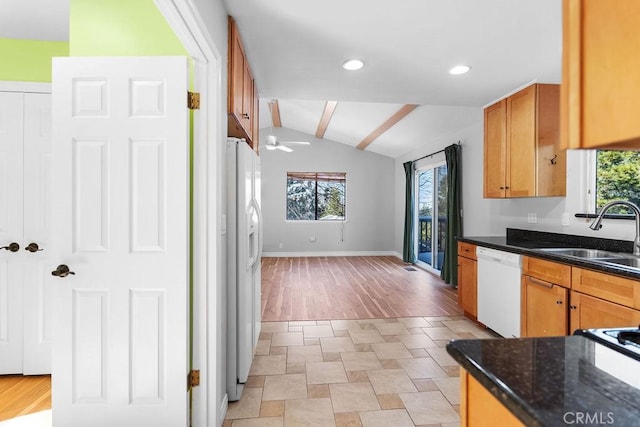 kitchen with a healthy amount of sunlight, lofted ceiling, sink, and white appliances