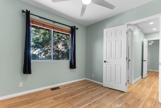 unfurnished bedroom with ceiling fan and light hardwood / wood-style floors