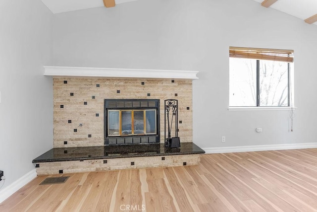 interior details featuring hardwood / wood-style flooring and a tiled fireplace