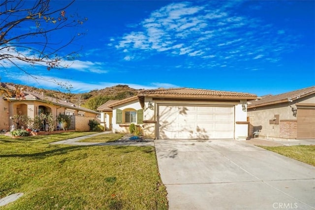 view of front of home featuring a garage and a front lawn