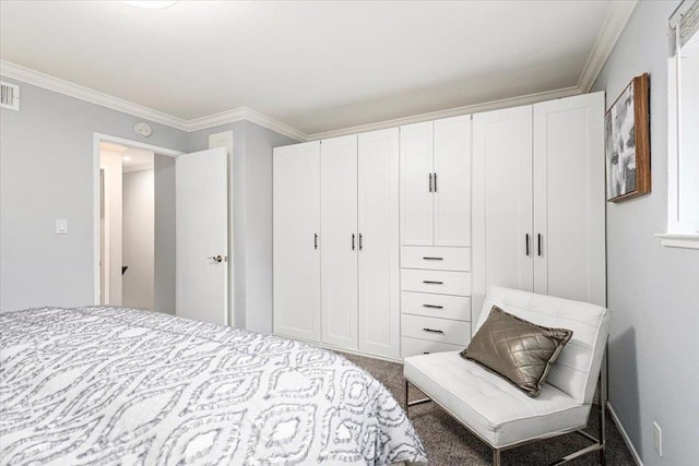 carpeted bedroom featuring ornamental molding and a closet