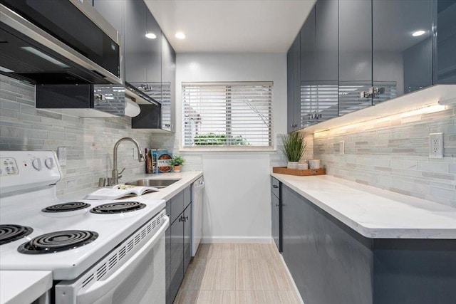 kitchen featuring sink, backsplash, and white appliances