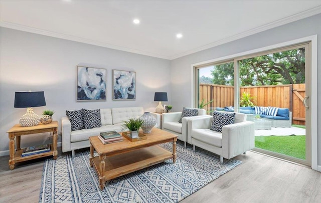 living room featuring ornamental molding and light wood-type flooring