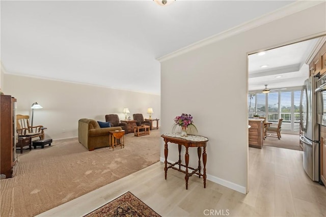 living room with crown molding and light wood-type flooring