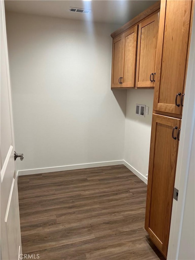 washroom featuring cabinets, washer hookup, and dark hardwood / wood-style floors