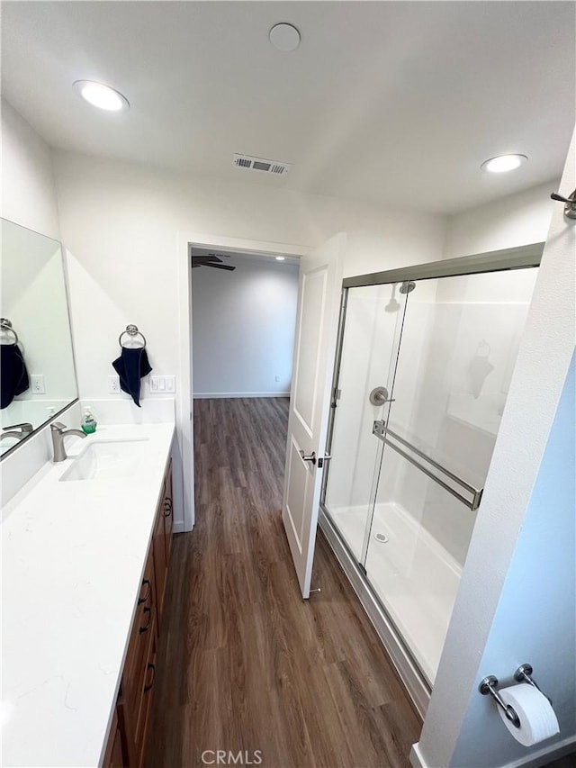 bathroom featuring a shower with door, wood-type flooring, and vanity