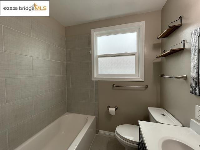 full bathroom with vanity, tiled shower / bath combo, and toilet