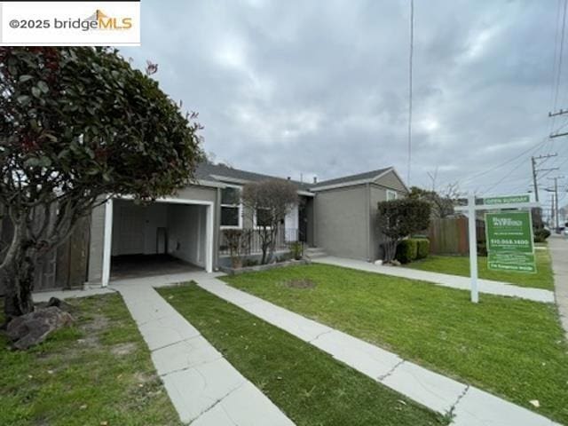 view of front of house with a garage and a front lawn