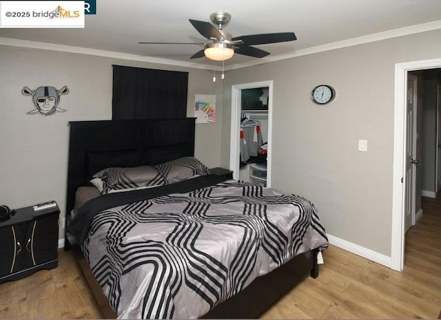 bedroom featuring crown molding, ceiling fan, light hardwood / wood-style floors, and a closet