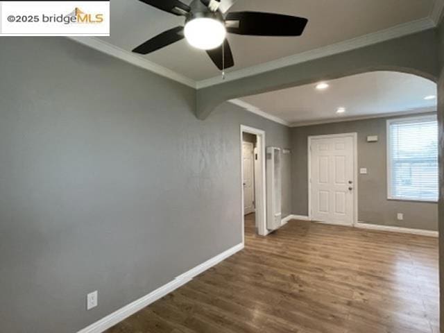 interior space featuring crown molding, ceiling fan, and wood-type flooring