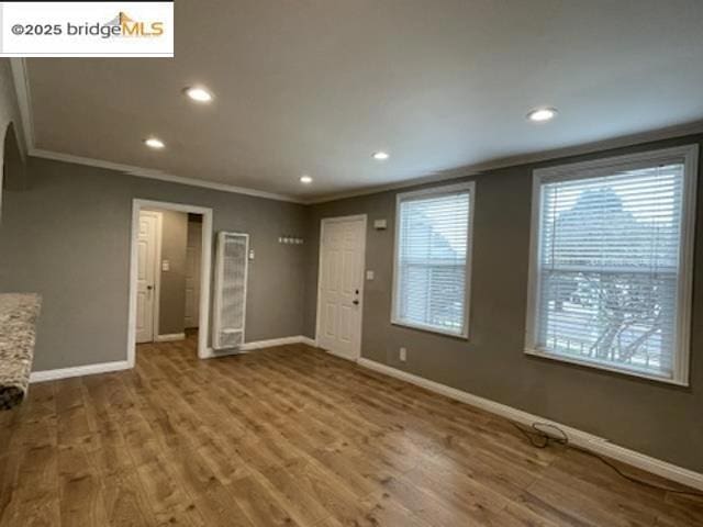 interior space featuring crown molding and hardwood / wood-style flooring