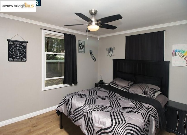 bedroom with ornamental molding, ceiling fan, and light wood-type flooring