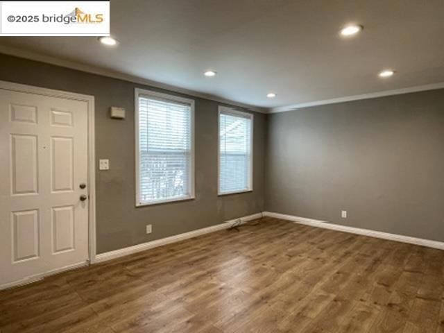 entryway featuring crown molding and dark hardwood / wood-style floors