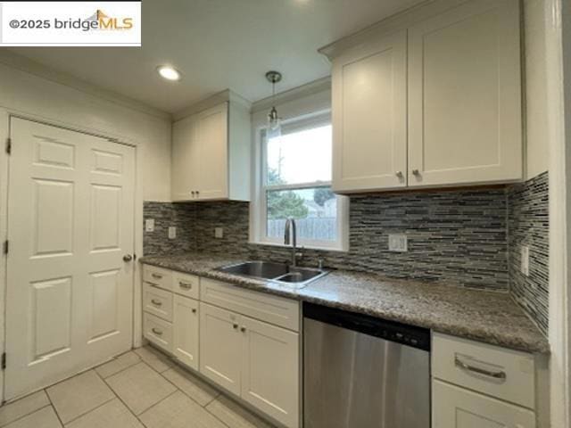 kitchen featuring white cabinetry, stainless steel dishwasher, sink, and light tile patterned floors