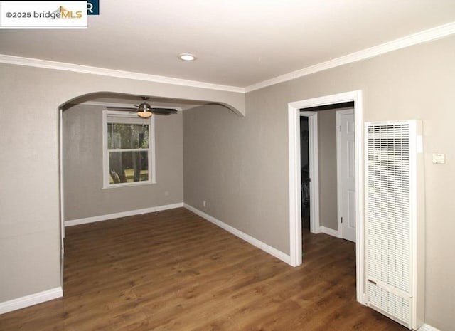 unfurnished room with dark hardwood / wood-style flooring, ornamental molding, and ceiling fan