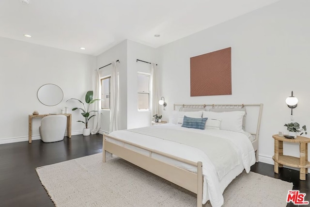 bedroom with dark wood-type flooring